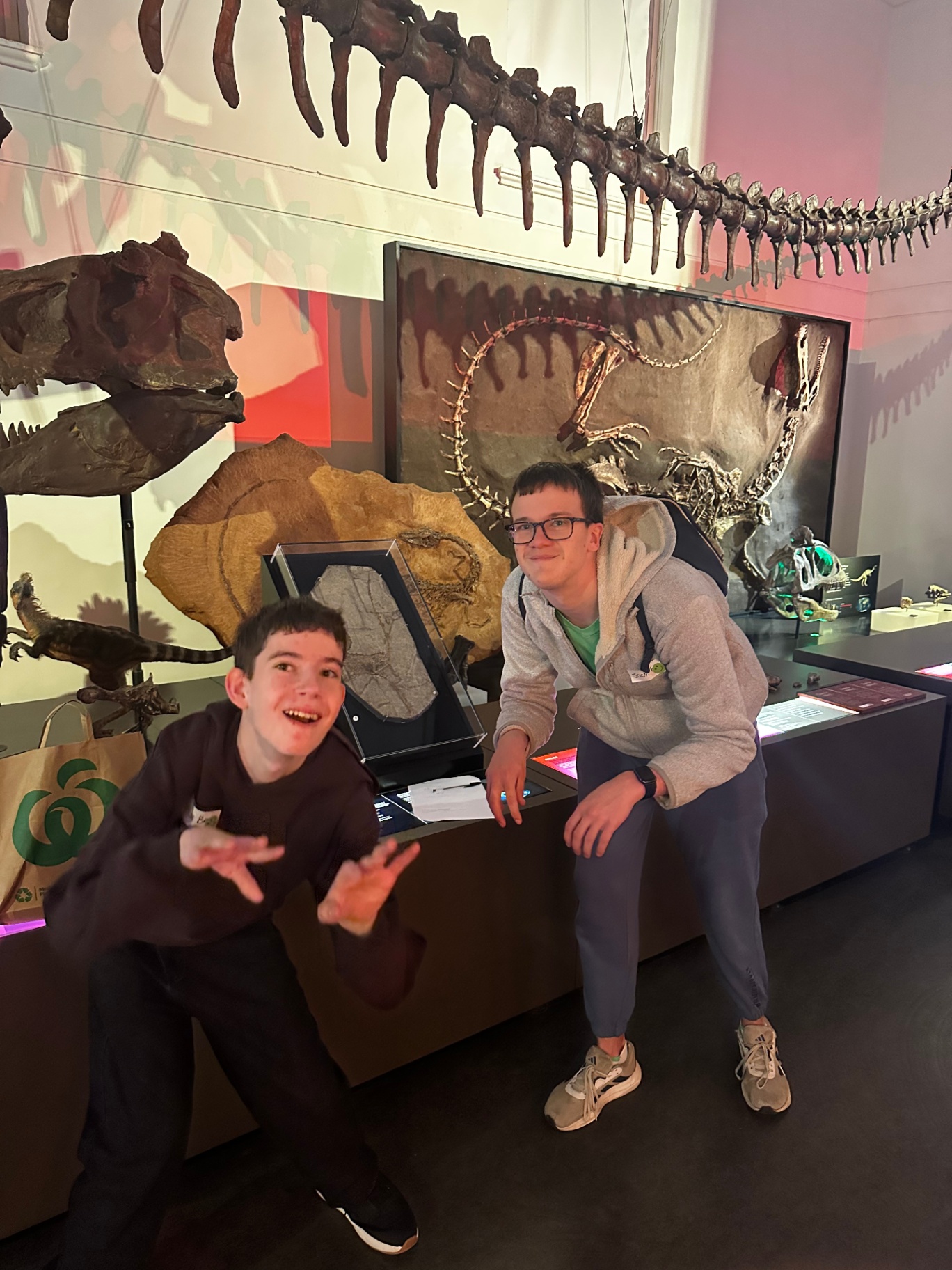 With George mates posing with a dinosaur fossil at the Australian Museum