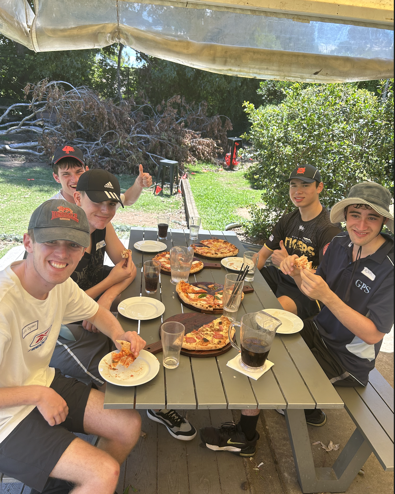 Group enjoying pizza together outdoors
