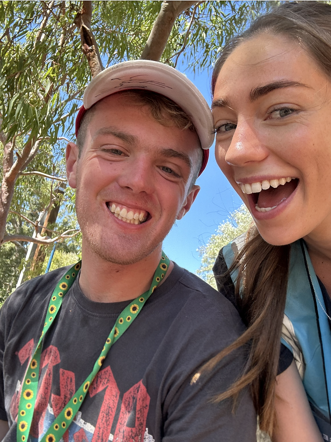 A smiling young man and woman outdoors